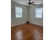 This bedroom features hardwood floors, neutral walls, and bright natural light from the two windows at 3329 Draper Ave, Charlotte, NC 28205