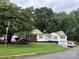 Charming home featuring a well-manicured lawn, complemented by lush trees and a cozy front porch at 3329 Draper Ave, Charlotte, NC 28205