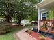 Inviting view of the front yard featuring a gravel path, colorful mulch, and a glimpse of the neighbor's home at 3329 Draper Ave, Charlotte, NC 28205
