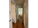 Hallway leading to bedrooms with hardwood floors, neutral walls, and white trim and doors at 3329 Draper Ave, Charlotte, NC 28205