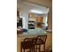 The open-concept kitchen features wood cabinets, modern appliances, and a glass countertop with bar seating at 3329 Draper Ave, Charlotte, NC 28205