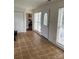 Sunroom features tiled floors, white trim, many windows for natural light, closet, and view of a bedroom at 3329 Draper Ave, Charlotte, NC 28205