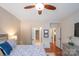 Spacious bedroom with ceiling fan and access to hallway at 8219 Bridgegate Dr, Huntersville, NC 28078