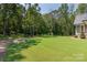 Large backyard with grassy area and mature trees at 859 Irish Creek Dr, Landis, NC 28088