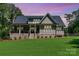Enjoy outdoor living with this backyard featuring a covered porch and lush lawn at 859 Irish Creek Dr, Landis, NC 28088