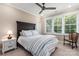 Bright bedroom with dark wood bed frame and window coverings at 859 Irish Creek Dr, Landis, NC 28088