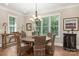 Bright dining room features a round table, wicker chairs, and a chandelier at 859 Irish Creek Dr, Landis, NC 28088