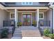 Inviting front porch with double doors and stone steps at 859 Irish Creek Dr, Landis, NC 28088