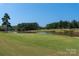 Scenic golf course with pond and lush green at 859 Irish Creek Dr, Landis, NC 28088