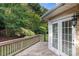Backyard wood deck featuring french doors, railing, and lush foliage at 191 Melbourne Dr, Fort Mill, SC 29708