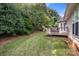 View of the backyard featuring a wooden deck and lush greenery at 191 Melbourne Dr, Fort Mill, SC 29708