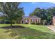 Well-maintained brick home with lush green lawn, mature trees, and charming curb appeal at 191 Melbourne Dr, Fort Mill, SC 29708