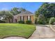 Lovely brick home boasts a spacious lawn, mature trees, and a long driveway at 191 Melbourne Dr, Fort Mill, SC 29708