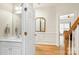 Hallway view showcasing hardwood floors, decorative molding, and a glimpse of the bathroom at 191 Melbourne Dr, Fort Mill, SC 29708