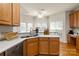 Kitchen interior with granite countertops, stainless steel appliances, and wooden cabinets at 191 Melbourne Dr, Fort Mill, SC 29708