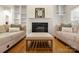Fireplace with built-in shelves and hardwood flooring in the home's living room at 191 Melbourne Dr, Fort Mill, SC 29708