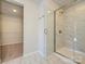 Bathroom with walk-in shower, marble tile, and spacious closet at 10513 Boudreaux St, Huntersville, NC 28078