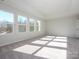 Well-lit bedroom featuring carpet floors and multiple windows at 10513 Boudreaux St, Huntersville, NC 28078