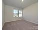 Simple bedroom with neutral walls and carpet flooring at 10513 Boudreaux St, Huntersville, NC 28078