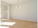 Bright dining room features hardwood floors and a stylish chandelier at 10513 Boudreaux St, Huntersville, NC 28078