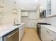 Modern kitchen with white cabinets, quartz countertops, and island at 10513 Boudreaux St, Huntersville, NC 28078