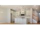 Modern kitchen with white cabinets, a large island, and recessed lighting at 10513 Boudreaux St, Huntersville, NC 28078
