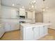 Modern kitchen with white cabinets, quartz countertops, and island at 10513 Boudreaux St, Huntersville, NC 28078