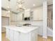 Modern kitchen with white cabinets, quartz countertops, and island at 10513 Boudreaux St, Huntersville, NC 28078