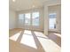 Sunlit living room with hardwood floors and access to backyard at 10513 Boudreaux St, Huntersville, NC 28078