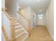 Light-filled entryway with hardwood floors and a wooden staircase at 10513 Boudreaux St, Huntersville, NC 28078