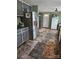 A kitchen with tile floors, painted cabinets, a stainless steel refrigerator, and a white door at 735 Ned Marsh Rd, Salisbury, NC 28146