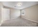 Neutral bedroom with a light fixture, plush carpeting, and a bright window at 101 Turner Dr, Clover, SC 29710