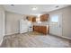 Functional kitchen with wooden cabinets, white appliances, and wood-look vinyl floors at 101 Turner Dr, Clover, SC 29710