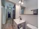 Contemporary bathroom with gray vanity and view of hallway at 818 N Jackson St, Salisbury, NC 28144