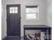 Clean entryway with black door, small table, and shoe storage at 818 N Jackson St, Salisbury, NC 28144