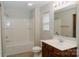 Bright bathroom featuring a shower-tub combo and a wood vanity at 1327 Phil Oneil Dr, Charlotte, NC 28215