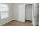 Bedroom with large window, neutral carpet, and open closet at 1327 Phil Oneil Dr, Charlotte, NC 28215