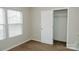 A bright bedroom featuring neutral walls and carpet and a closet at 1327 Phil Oneil Dr, Charlotte, NC 28215