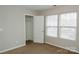A bright bedroom featuring neutral walls, carpet and two windows at 1327 Phil Oneil Dr, Charlotte, NC 28215