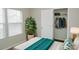 Cozy bedroom featuring ample natural light, closet, and a decorative plant at 1327 Phil Oneil Dr, Charlotte, NC 28215