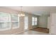 Bright dining room featuring tile flooring, chandelier, and large windows allowing for plenty of natural light at 1327 Phil Oneil Dr, Charlotte, NC 28215