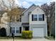 Charming two-story home featuring gray siding, black shutters, well-maintained lawn, and a one-car garage at 1327 Phil Oneil Dr, Charlotte, NC 28215