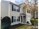 Attractive two-story home featuring gray vinyl siding, black shutters, and a convenient one-car garage at 1327 Phil Oneil Dr, Charlotte, NC 28215