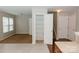 View of hallway with carpeted floor, closet with wire shelving, and white doors at 1327 Phil Oneil Dr, Charlotte, NC 28215