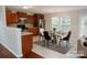 Bright kitchen features stainless steel appliances, wood cabinets, and an adjacent dining area with a glass table at 1327 Phil Oneil Dr, Charlotte, NC 28215