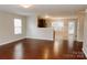 Spacious living room features hardwood floors and a view of the open-concept kitchen and dining area at 1327 Phil Oneil Dr, Charlotte, NC 28215