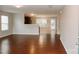Spacious living room featuring hardwood floors and a seamless transition to the adjacent kitchen and dining areas at 1327 Phil Oneil Dr, Charlotte, NC 28215