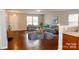 Inviting living room featuring hardwood floors, a comfortable gray sofa, and ample natural light from large windows at 1327 Phil Oneil Dr, Charlotte, NC 28215