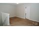 Loft area with carpeted floor and neutral walls; door leads to another room at 1327 Phil Oneil Dr, Charlotte, NC 28215