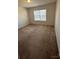 Neutral bedroom boasting ample sunlight with large window and soft, carpeted flooring at 2548 Sweet Birch Ct, Gastonia, NC 28054